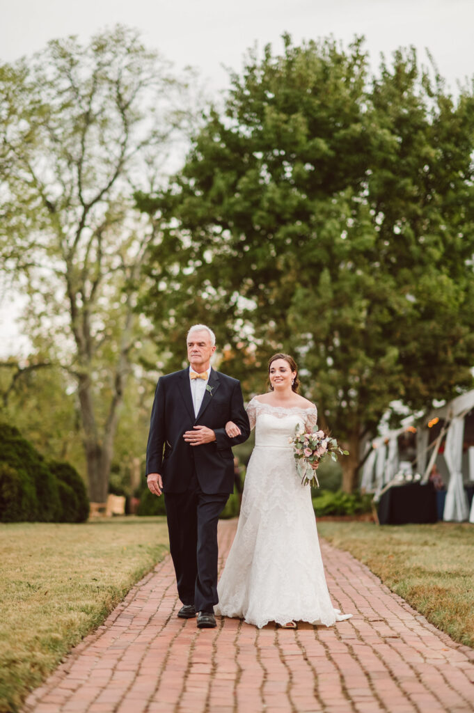 A father walks his daughter down the aisle at River Farm in Alexandria Virginia.